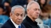 FILE - Israeli Prime Minister Benjamin Netanyahu, left, and Israeli Defense Minister Yoav Gallant attend a ceremony for the 70th cohort of military combat officers, at an army base near Mitzpe Ramon, Oct. 31, 2024. 