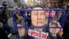 Protesters carry a caricature depicting an imprisoned South Korean President Yoon Suk Yeol as they march to the presidential office after a rally demanding his impeachment in Seoul, South Korea, Dec. 12, 2024. 