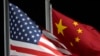 FILE - The American and Chinese flags wave at Genting Snow Park ahead of the 2022 Winter Olympics, in Zhangjiakou, China, Feb. 2, 2022. 