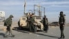 Members of Kurdish-led Syrian Democratic Forces stand along a street after rebels seized the capital and ousted Syria's Bashar al-Assad, in Hasakah, Syria, Dec. 11, 2024.