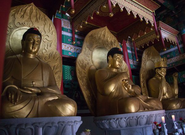 North Koreans pray to Buddha statues for good luck