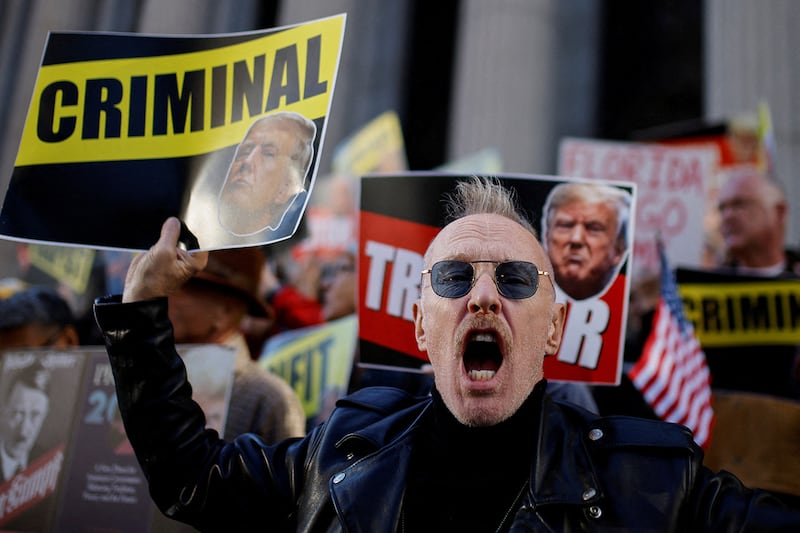 An opponent of Republican presidential nominee and former President Donald Trump shouts in New York City, Oct. 27, 2024.