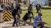 Kenya Police officers and security personnel take position to protect the Kenyan Parliament as protesters try to storm the building during a nationwide strike to protest against tax hikes and the Finance Bill 2024 in downtown Nairobi, on June 25, 2024.