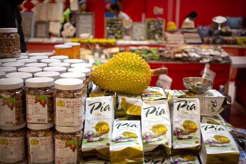 A reproduction of a durian fruit sits atop packages of durian cakes from Vietnam at a shopping mall in Beijing, Jan. 10, 2020.