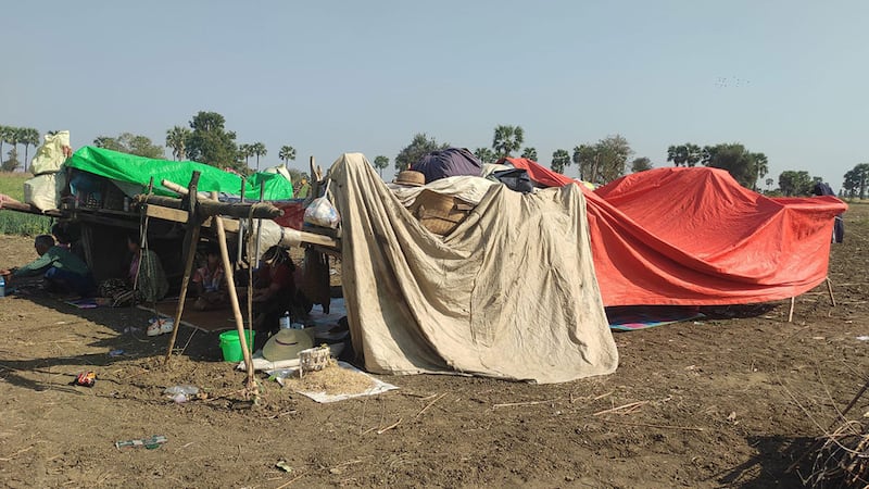 People displaced by fighting huddle under tarps in Pale township, Sagaing region, in March 2024.