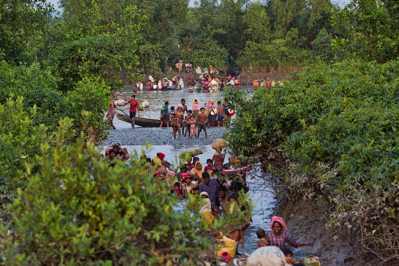 Groups of Rohingya Muslims cross the Naf River on the border between Myanmar and Bangladesh, near Palong Khali, Bangladesh, Nov. 1, 2017.