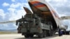 FILE - First parts of a Russian S-400 missile defense system are unloaded from a Russian plane near Ankara, Turkey, July 12, 2019. 