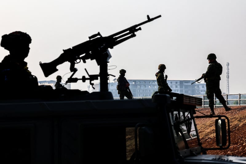 Military personnel stand guard as hundreds of refugees crossed over the river frontier between Myanmar and Thailand on Friday following the fall of a strategic border town to rebels fighting Myanmar\'s military junta, in Mae Sot, Tak province, Thailand, April 2024. (REUTERS/Athit Perawongmetha)