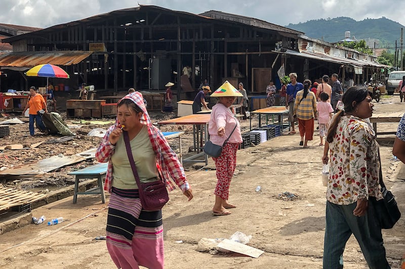 People walk though a market area on Sept. 10, 2024, as it’s being rebuilt in Lashio in Myanmar\'s northern Shan state, after the Myanmar National Democratic Alliance Army (MNDAA) seized the town from Myanmar\'s military in August.