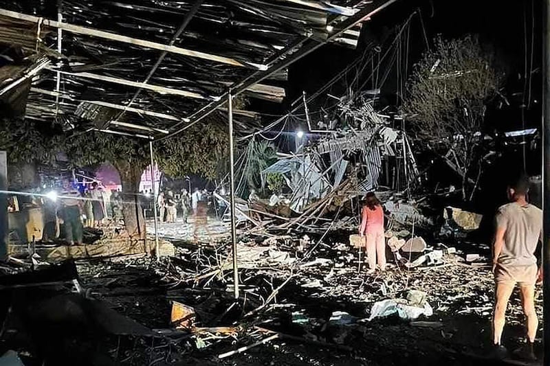 People gather around a destroyed building following an airstrike in Namhkham township in Myanmar\'s northern Shan state, Sept. 6, 2024.