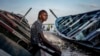 Salamba Ndiaye, a 28-year-old who tried to migrate to Europe twice, poses for a photo at the beach in Thiaroye-Sur-Mer, Senegal, Aug. 23, 2024. 