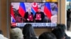 A TV screen shows a file image of North Korean leader Kim Jong Un, right, and Russian President Vladimir Putin in Pyongyang, during a news program at the Seoul Railway Station in Seoul, South Korea, Nov. 12, 2024.