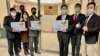 Eric Huang, newly appointed director to the representative office, third from right, poses with other staffers outside the Taiwan Representative Office in Vilinius, Lithuania, Nov. 18, 2021.