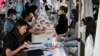 FILE -The photo taken on Aug. 26, 2022 shows young people attending a job fair in Beijing.