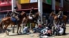 Police on horses surround protesters during protests against abductions in Nairobi, Dec. 30, 2024.