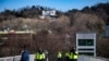 TOPSHOT - Police officers stand guard outside of impeached South Korea president Yoon Suk Yeol's residence (back) in Seoul on Jan. 2, 2025.