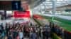 FILE - In this photo released by Xinhua News Agency, passengers line up to board a train of the Laos-China Railway at Kunming Railway Station in Kunming in southwestern China's Yunnan Province, Dec. 3, 2021. 