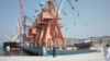 FILE - Laborers walk through the Gwadar, Pakistan, port on Oct. 4, 2017.